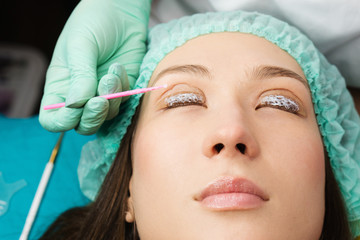 Eyelash care treatment procedures. Staining, curling, laminating for lashes. Beauty model with...