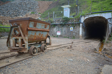 Fototapeta na wymiar rusty metal wagon at the entrance to a Chinese company owned mine in Kilembe