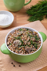 Buckwheat porridge with mushrooms, traditional russian food. Vertical orientation