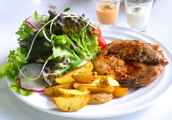 Grilled Pork Chop Pepper Barbecue Steak with baked potato, fresh salad, tomato and vegetable on the white plate. Healthy food lifestyle, ready to eat with thousand salad sauce and cream salad sauce.