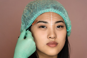 Master makes eyebrows. Eyebrow lamination. The girl makes eyebrows in the salon. Beautiful eyebrow...