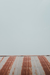 The roof of a home  on a minimalistic sky background.