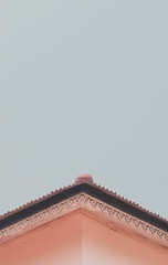 The roof of a home  on a minimalistic sky background.