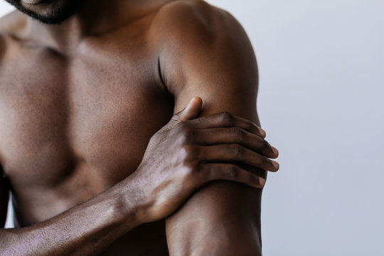 Man touching his arm