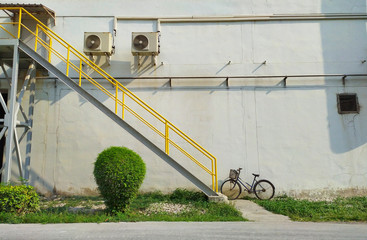 The yellow stair with an old bicycle