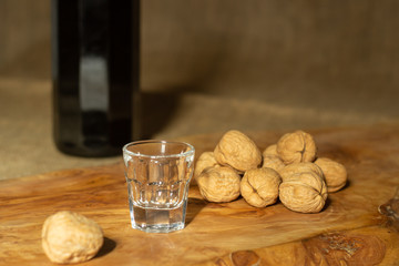 empty glass with walnuts and bottle of walnut liqueur