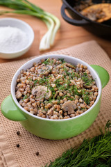 Buckwheat porridge with mushrooms, traditional russian food. Vertical orientation