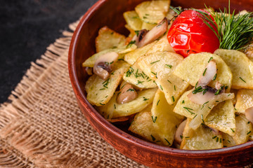 Rustic potato wedges with cheese, herbs and tomato sauce on black background