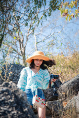 Woman hiking in forest on mountain with cliff