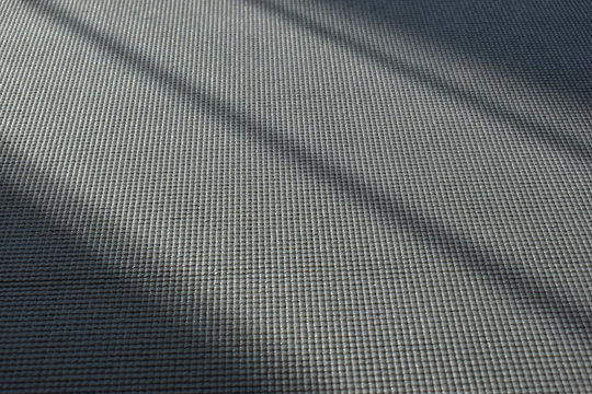 yoga mat put on floor in side fitness gym, image sport exercise background with sunlight in the morning day