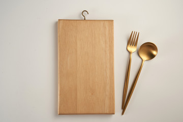 Cutlery and  empty cutting board food background concept