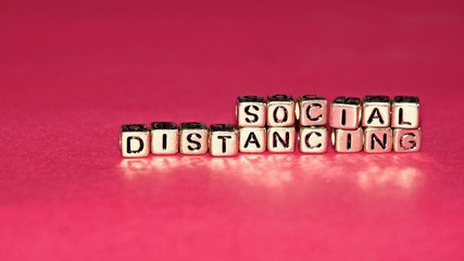 Beads with words "Social Distancing". Selected focus.