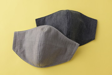 design of fashion face mask handmade from fabric cotton cloth, objects on yellow background