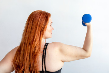 Girl working out with dumbbell