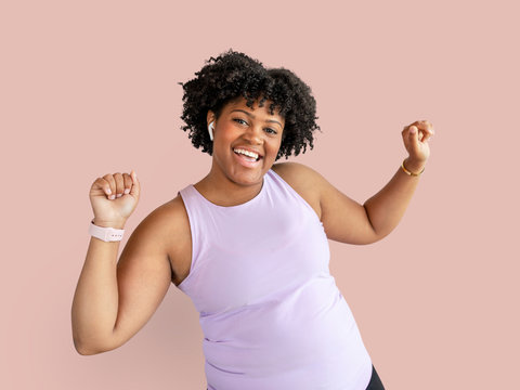 Woman In Activewear Listening To Music