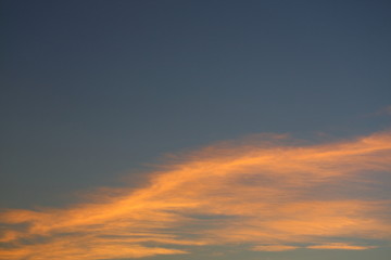 Fototapeta premium evening clear blue sky with orange sunlight shine through cloud