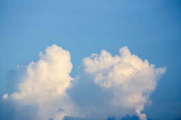 sunlight through fluffy white cloud on clear blue sky background