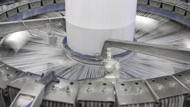 Lofty conical column rotating and knitting large plastic canvases at agro plant 