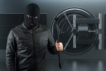 Masked burglar with crowbar in the background. Bank vault doors, large safe, bank robbery. The...