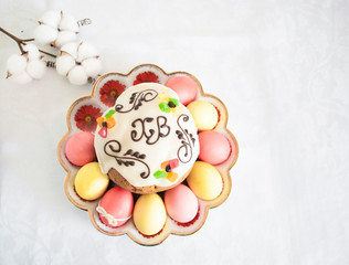 Easter cake around him painted eggs on a special plate