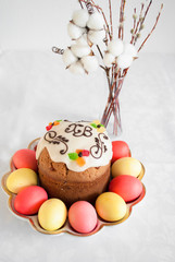 Easter cake with colored eggs and a vase