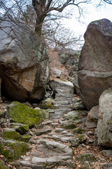 Stone stairs in between two rocks in Bukhansan National Park near Seoul in South Korea on a cloudy winter day