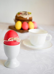 Easter table with a red egg in the foreground