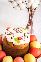 Easter cake with eggs close-up and a vase with a flower