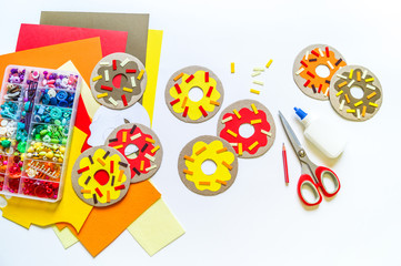 Garland of cardboard and paper donuts.