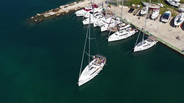 Sailboat going backwards to berth - Aerial Drone View