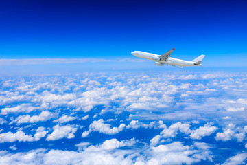 Fototapeta na wymiar Commercial airplane flying above the clouds,travel concept.