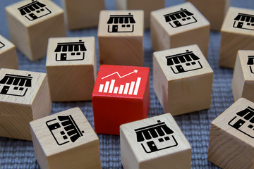 Pile of a cube shape wooden toy blog with franchise bussiness icons store and graph for growth and...