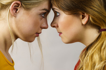 Fototapeta premium Two girls looking serious at each other.