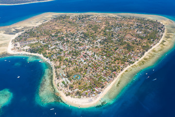 Aerial view of a beautiful, small, tropical island surrounded by fringing coral reef (Gili Air,...