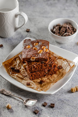 brownie cake wit hazelnut and chocolate on concrete table
