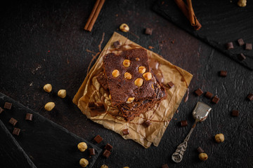 brownie cake wit hazelnut and chocolate on dark grunge table