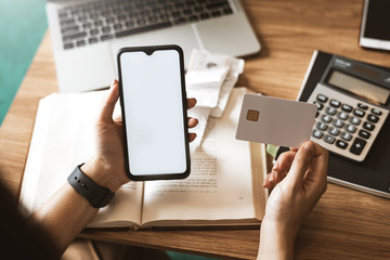 Woman using mobile smartphone and credit card at home. Shopping Online.