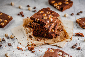 brownie cake wit hazelnut and chocolate on concrete table