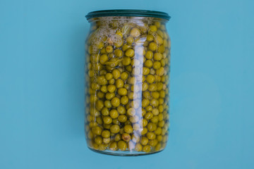 Canned green peas on a blue background.Food for donations.Food aid.Food delivery.
