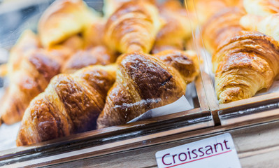 Fresh croissants put up for sale in a bakery store
