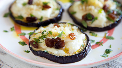 Aubergine stuffed with cheese and raisins
