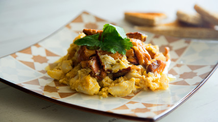 Cod with scrambled eggs and mushrooms