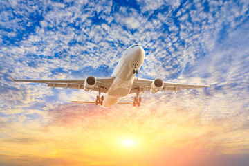 Fototapeta premium Commercial airplane flying in beautiful sky at sunset,travel concept.