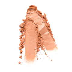 Smears of peach eyeshadow on white