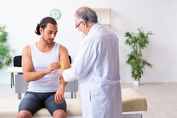 Young male patient visiting experienced doctor