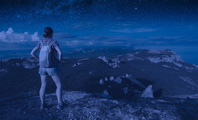 Fototapeta premium Girl hiker under the starry sky