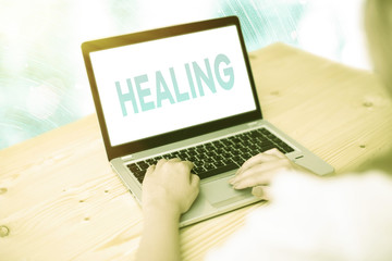 Conceptual hand writing showing Healing. Concept meaning process of making or becoming sound or...