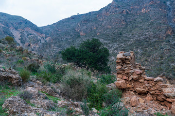 ruins of a farmhouse in Cejor next to the green river 