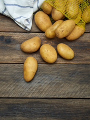 Potatoes on old wooden table.