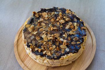 Cold cheesecake with chocolate coating, almonds and raisins